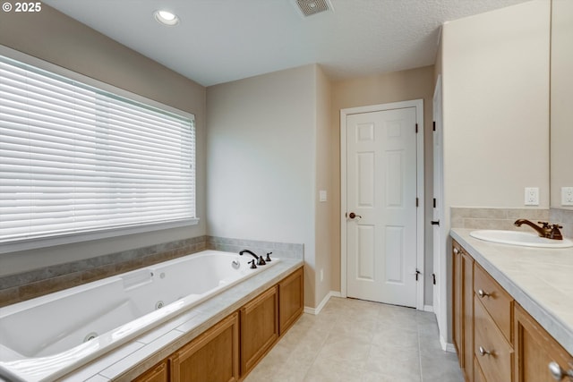 13605 NW Hogan St, Portland, OR 97229 - bathroom with vanity, a tub with jets, tile patterned floors, and recessed lighting
