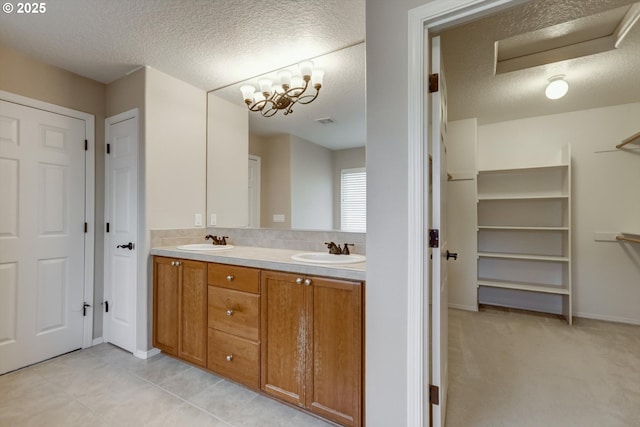 13605 NW Hogan St, Portland, OR 97229 - full bathroom featuring double vanity, a textured ceiling, baseboards, and decorative backsplash