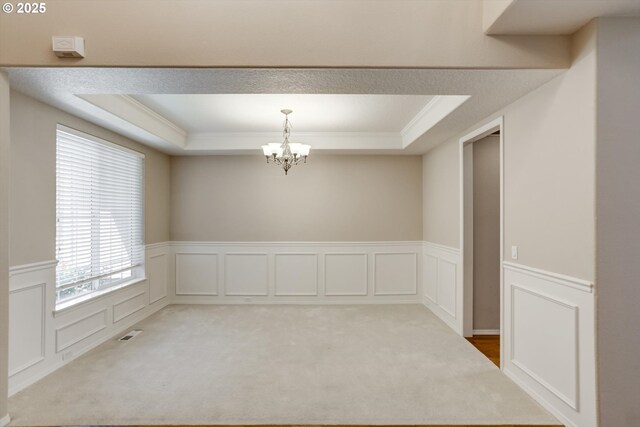 13605 NW Hogan St, Portland, OR 97229 - spare room with a raised ceiling, crown molding, a chandelier, a decorative wall, and carpet floors