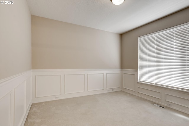13605 NW Hogan St, Portland, OR 97229 - spare room with a decorative wall, light carpet, and a wainscoted wall