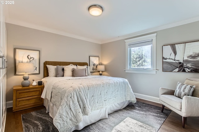 bedroom featuring crown molding, baseboards, and wood finished floors