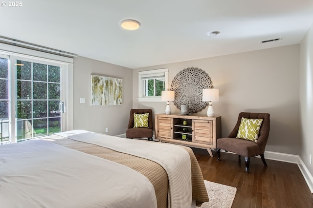 bedroom with access to exterior, dark wood-type flooring, visible vents, and baseboards