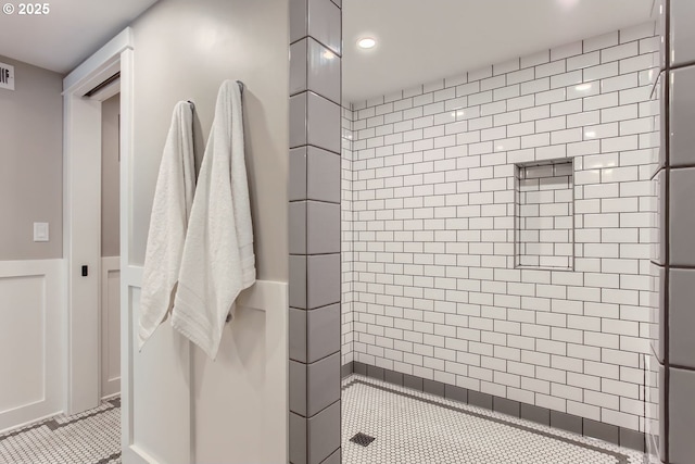 full bathroom featuring recessed lighting, visible vents, and a tile shower