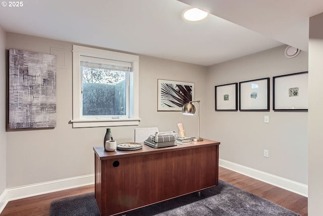 office with dark wood-style floors and baseboards