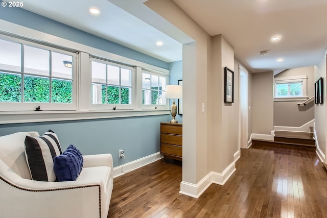 living area featuring a healthy amount of sunlight, baseboards, hardwood / wood-style floors, and recessed lighting