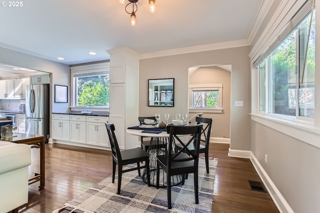 dining room featuring recessed lighting, visible vents, baseboards, ornamental molding, and dark wood finished floors