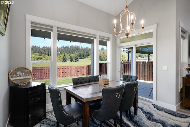 dining space with baseboards and a notable chandelier