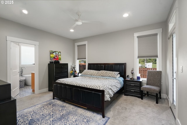 bedroom with recessed lighting, a ceiling fan, light carpet, ensuite bath, and baseboards