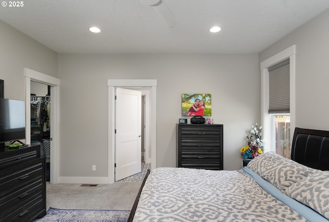 bedroom with recessed lighting, carpet floors, visible vents, baseboards, and a closet