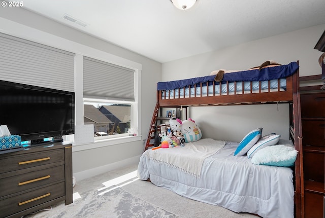 bedroom featuring baseboards, visible vents, and carpet flooring