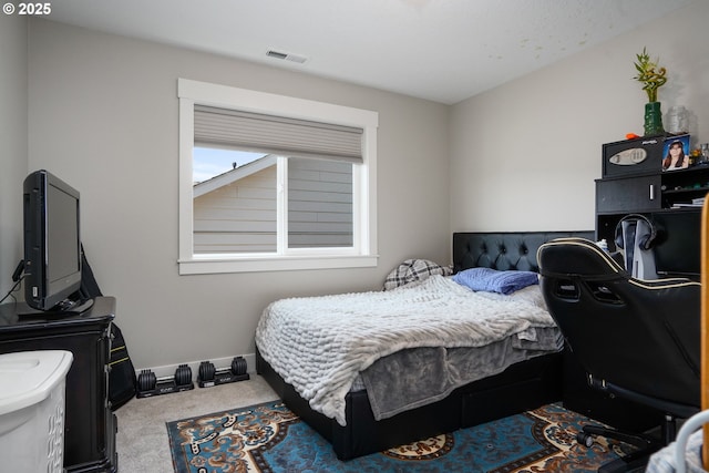 bedroom with carpet floors, visible vents, and baseboards