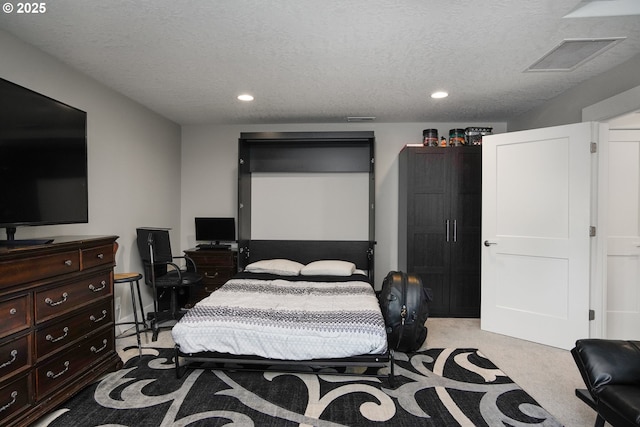 bedroom featuring a textured ceiling, recessed lighting, visible vents, and light colored carpet