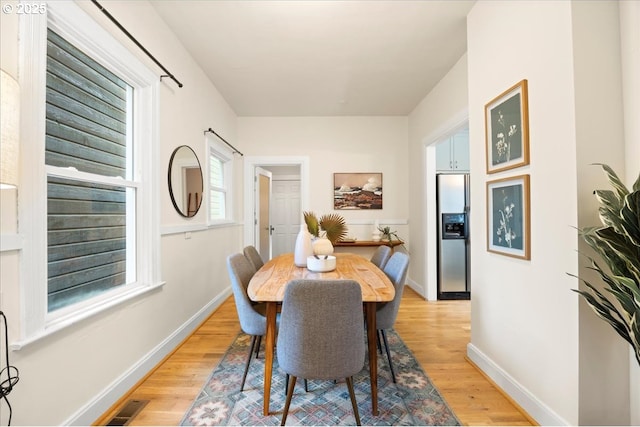 dining space with light wood-type flooring