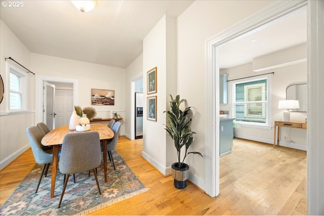 dining space with light hardwood / wood-style floors