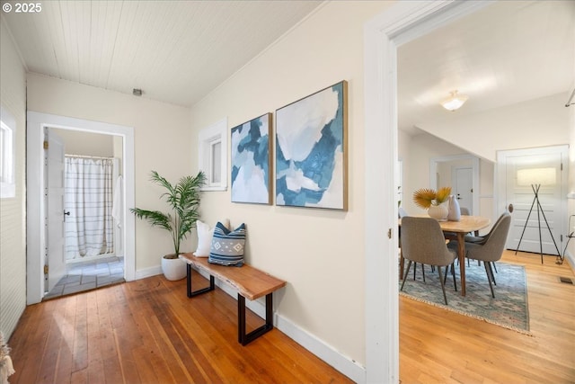 hall with hardwood / wood-style flooring