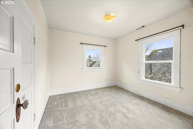 carpeted spare room featuring a healthy amount of sunlight