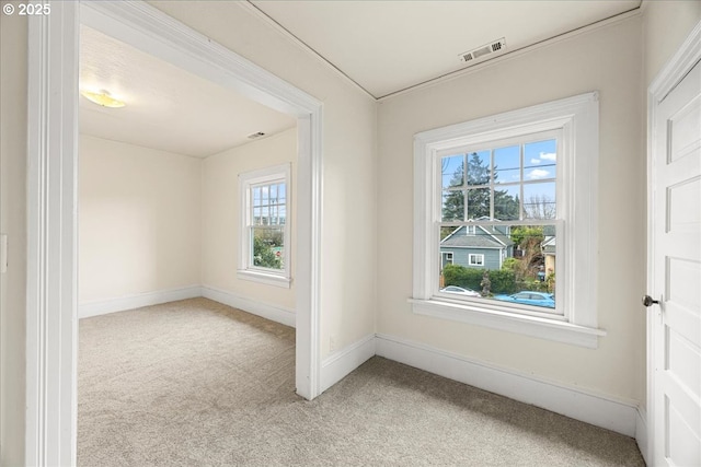 unfurnished room featuring light carpet