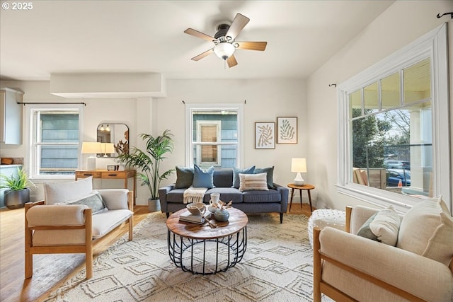 living room with light hardwood / wood-style floors and ceiling fan