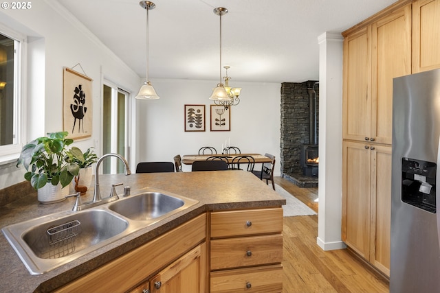 20 Silva Cutoff Rd, Lyle, WA 98635 - kitchen with a wood stove, a sink, light wood-style floors, dark countertops, and stainless steel fridge with ice dispenser