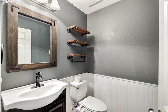 20 Silva Cutoff Rd, Lyle, WA 98635 - bathroom featuring toilet, visible vents, wainscoting, and vanity