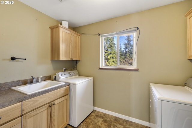 20 Silva Cutoff Rd, Lyle, WA 98635 - laundry room with baseboards, washing machine and dryer, cabinet space, and a sink