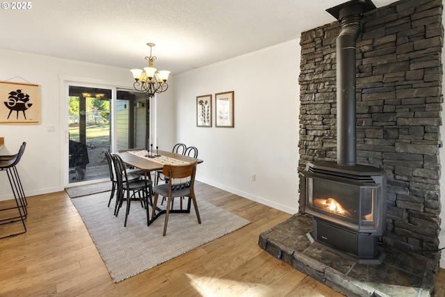 20 Silva Cutoff Rd, Lyle, WA 98635 - dining area featuring wood finished floors, ornamental molding, baseboards, a wood stove, and a notable chandelier