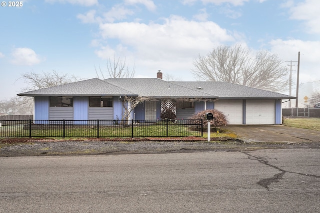 single story home featuring a garage and a front yard