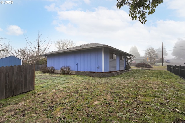 view of side of home with a lawn