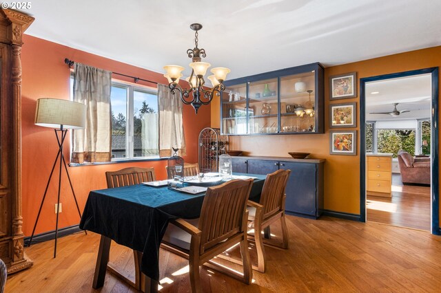 dining area with an inviting chandelier and wood finished floors