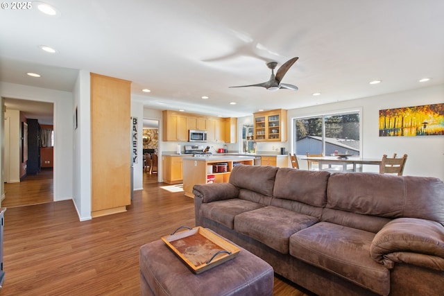 living area featuring recessed lighting, wood finished floors, and ceiling fan