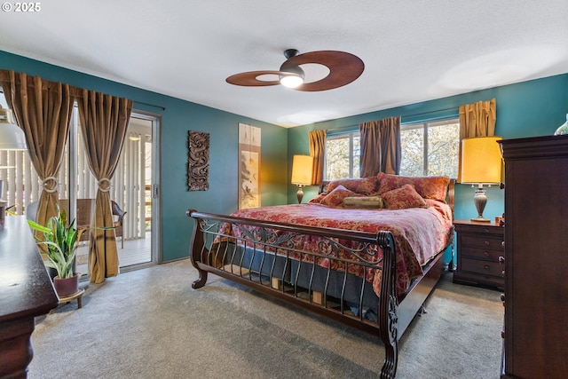 carpeted bedroom featuring ceiling fan and access to outside