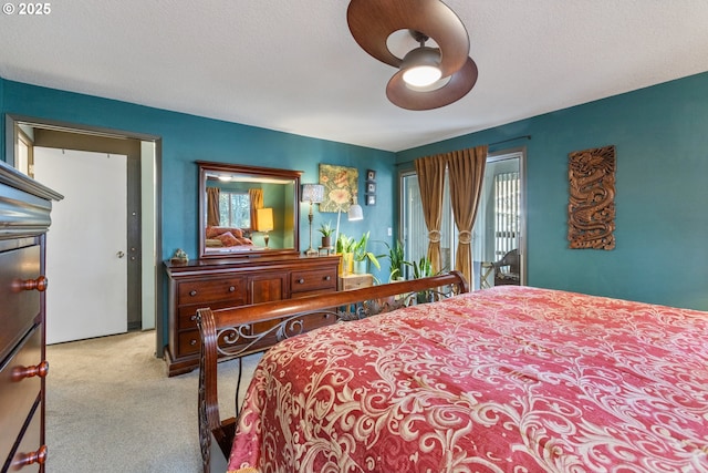 carpeted bedroom featuring access to exterior, multiple windows, a textured ceiling, and a ceiling fan