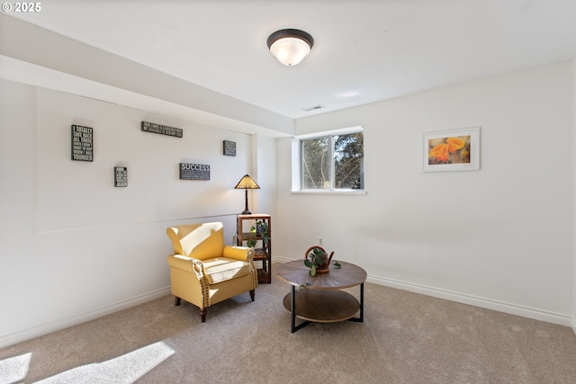 sitting room with visible vents, carpet floors, and baseboards