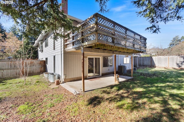 rear view of property featuring a patio, a yard, a fenced backyard, a deck, and central air condition unit