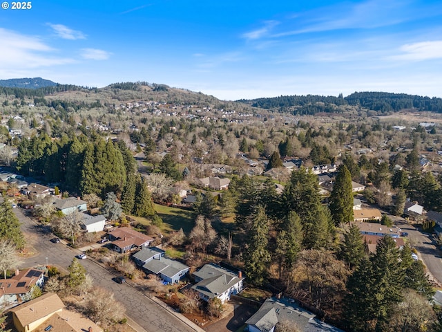 bird's eye view with a wooded view, a mountain view, and a residential view