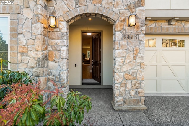 doorway to property with a garage