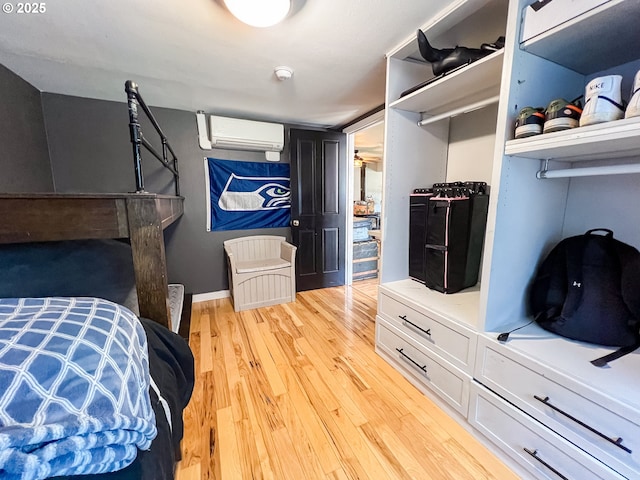 858 E Main St, John Day, OR 97845 - bedroom with a wall unit AC and light wood-type flooring