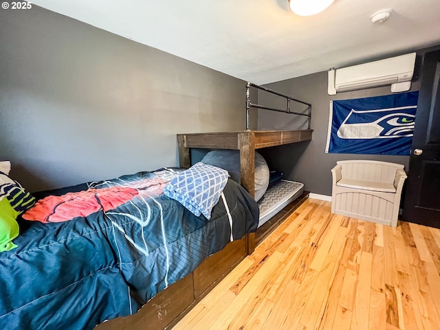 858 E Main St, John Day, OR 97845 - bedroom with a wall mounted AC and wood finished floors