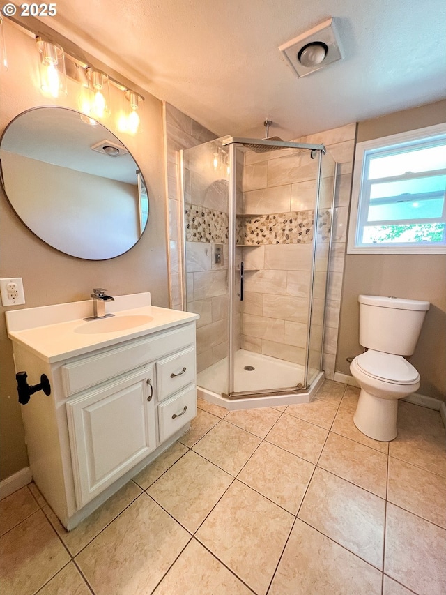 858 E Main St, John Day, OR 97845 - bathroom featuring vanity, a shower stall, toilet, and tile patterned floors