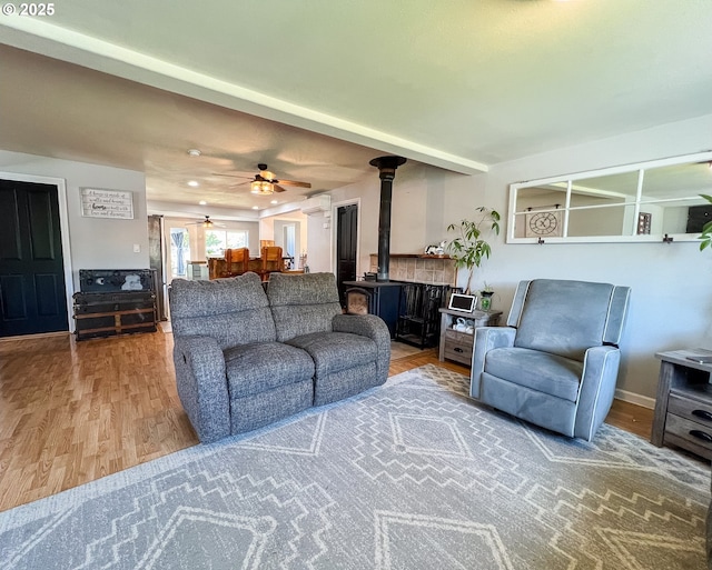 858 E Main St, John Day, OR 97845 - living area featuring a wood stove, a ceiling fan, and wood finished floors