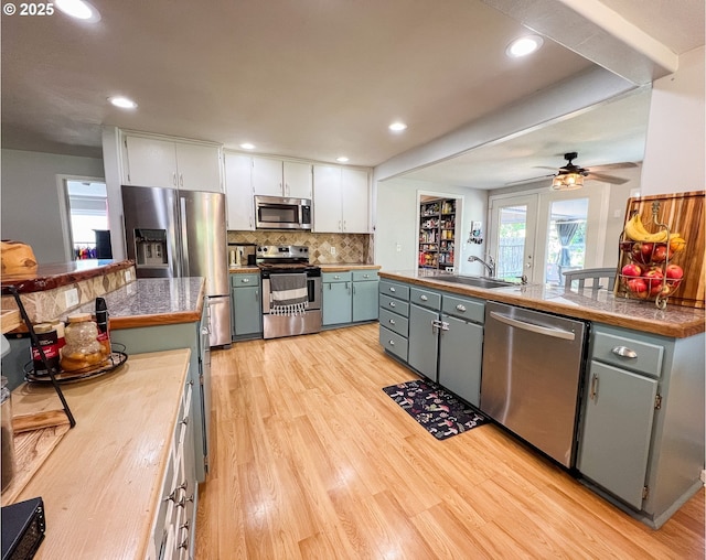 858 E Main St, John Day, OR 97845 - kitchen featuring stainless steel appliances, a sink, tile counters, light wood finished floors, and ceiling fan