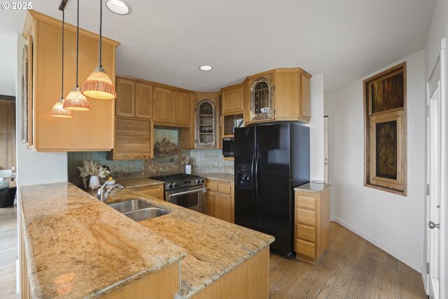 175 SW 85th Ave, Portland, OR 97225 - kitchen featuring stainless steel gas range, black refrigerator with ice dispenser, a peninsula, backsplash, and glass insert cabinets