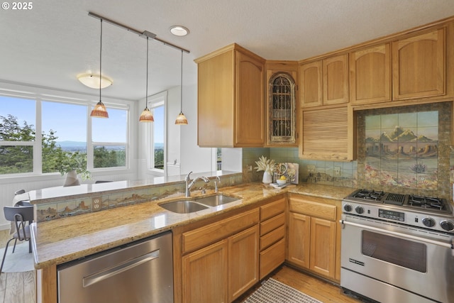 175 SW 85th Ave, Portland, OR 97225 - kitchen with appliances with stainless steel finishes, light stone countertops, light wood-style flooring, tasteful backsplash, and hanging light fixtures