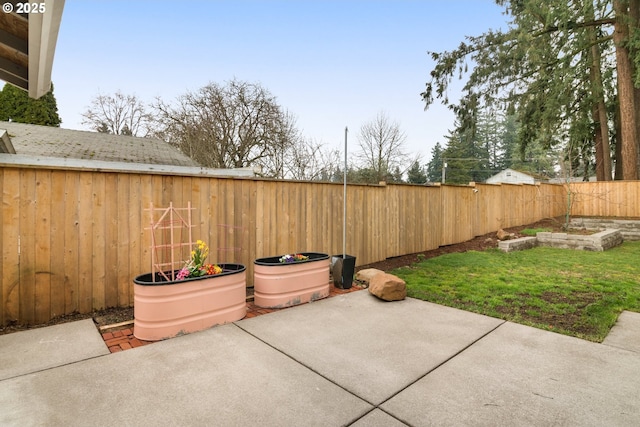 view of patio / terrace featuring a fenced backyard and a garden