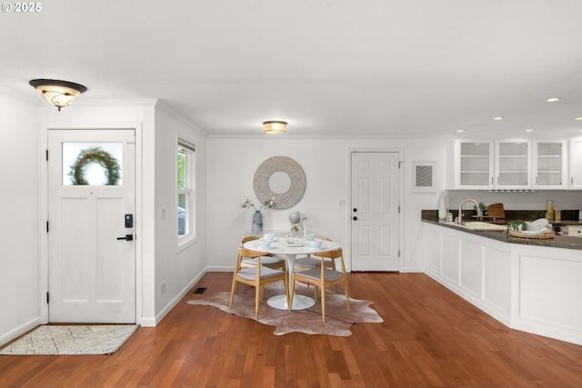 foyer featuring recessed lighting, ornamental molding, baseboards, and wood finished floors