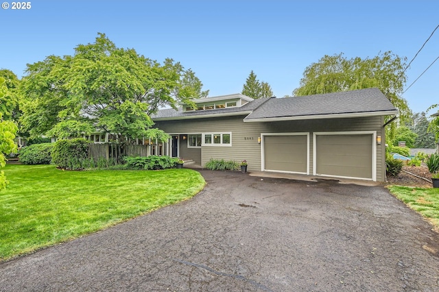 9843 SW 57th Ave, Portland, OR 97219 - view of front of house with an attached garage, a front yard, driveway, and roof with shingles