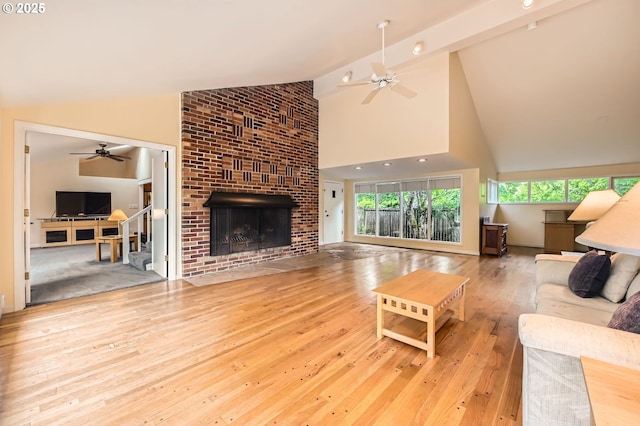 9843 SW 57th Ave, Portland, OR 97219 - living area featuring a ceiling fan, a fireplace, high vaulted ceiling, and wood-type flooring