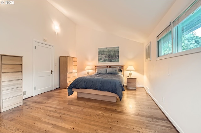 9843 SW 57th Ave, Portland, OR 97219 - bedroom featuring light wood-type flooring, baseboards, and high vaulted ceiling