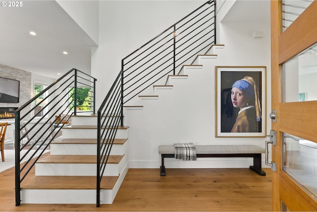 927 SW Maplecrest Ct, Portland, OR 97219 - stairway with wood finished floors, baseboards, recessed lighting, and a towering ceiling