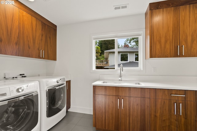 927 SW Maplecrest Ct, Portland, OR 97219 - laundry room featuring cabinet space, washer and dryer, tile patterned flooring, and baseboards